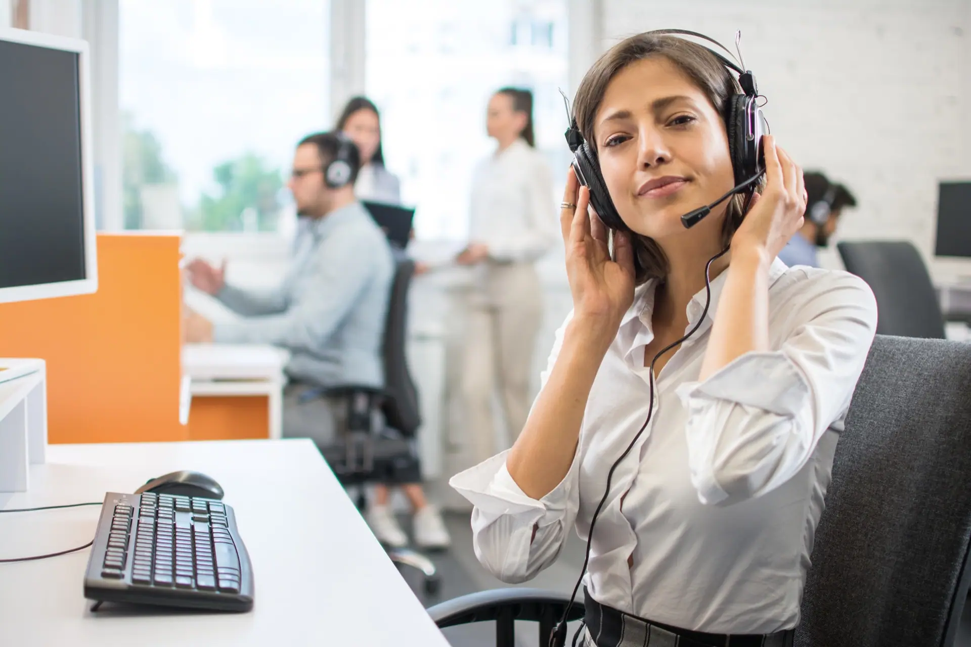Office coordinator on a headset handling client calls