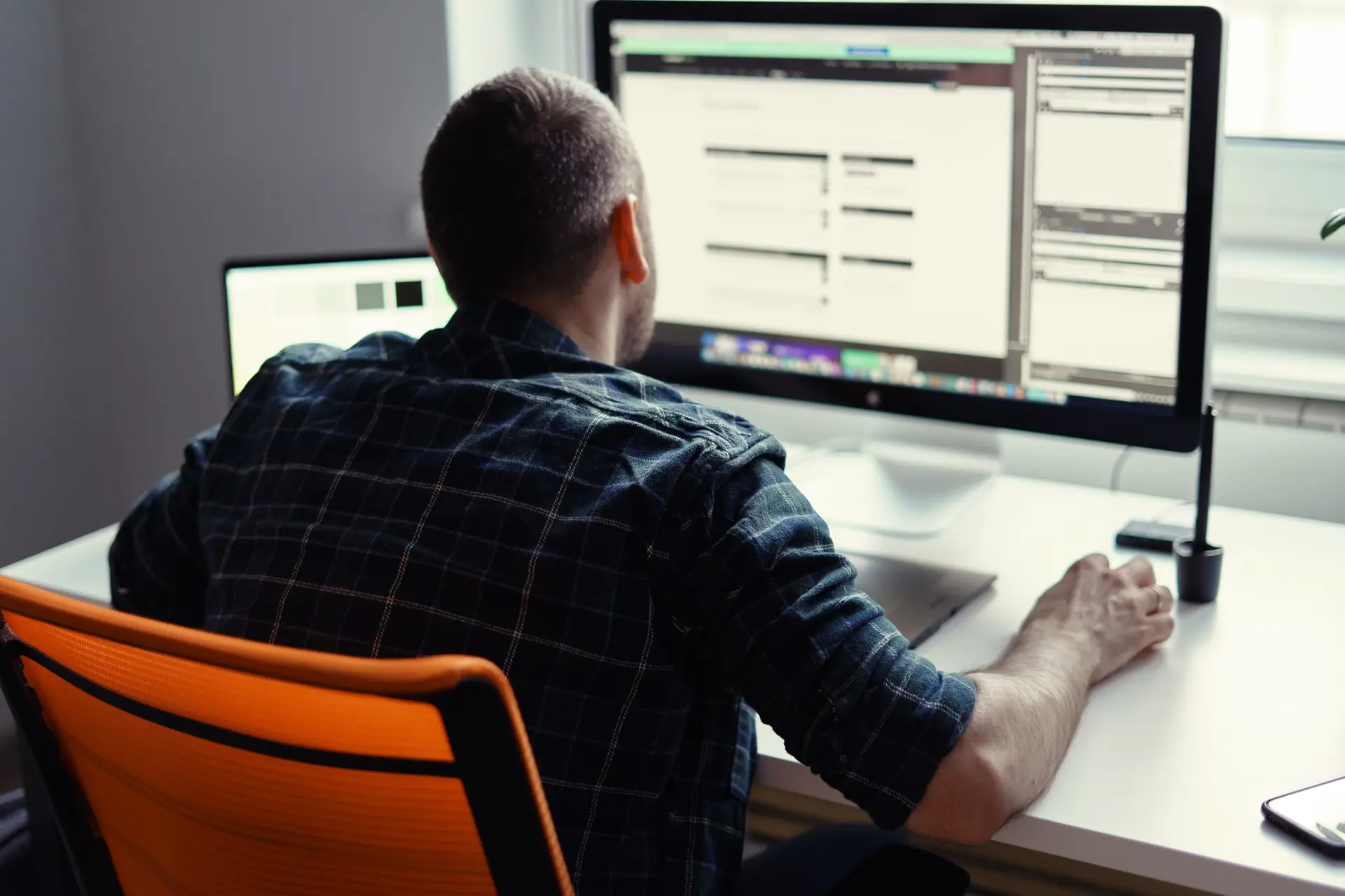 Appraiser at a desk working across two screens